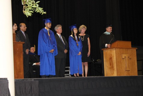 Valedictorian Nolan Vora and Salutatorian McDenzie Dixon are recognized with their parents by Principal Harris 