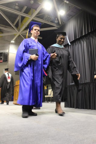 Mrs. Thomas escorts Will Rosa off the stage after receiving his diploma THS Graduation 2015
