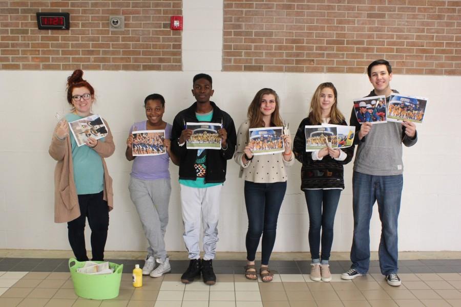 Anna Garners six Painting II students used photographs to paint the mural, which will hang on the cinderblock wall once occupied by lockers. From left are Cara Lowry, Keondra Thomas, Zack McIntosh, Sophie Petroskevich, Rachel Williams and Wyatt Herring.