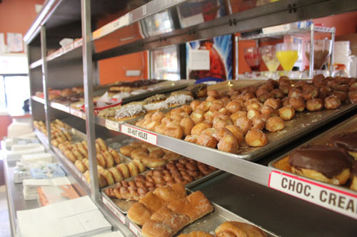 Doughnut holes and other flavors and styles sit hot and ready for waiting customers at Scarlets Do-Nuts.