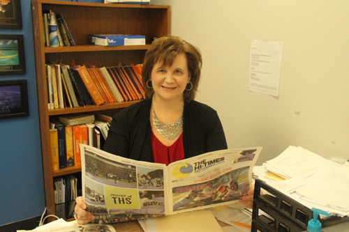Stephanie Spires, the new Hi-Times adviser, smiles for a picture at her desk.