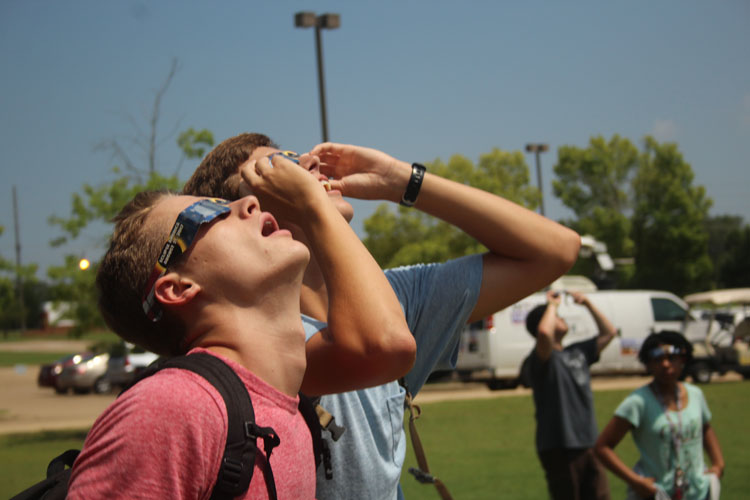 Seniors: Will Edwards and Carter Halbert view the eclipse through their solar eclipse glasses