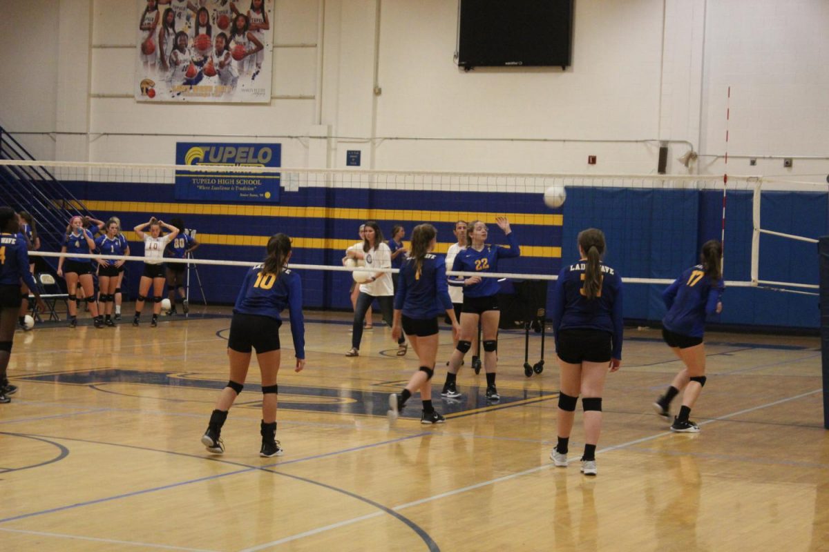 The Jv Squad warms up the Varsity Squad before the match against Oxford. 