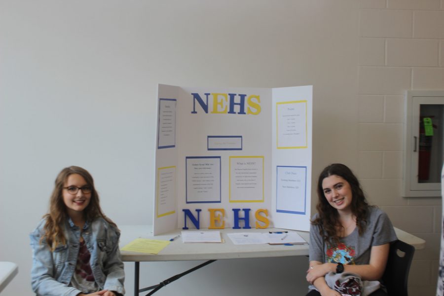 Claire Bailey and Emma Atkinson get ready to tell people about their club, National English Honor Society, NEHS.