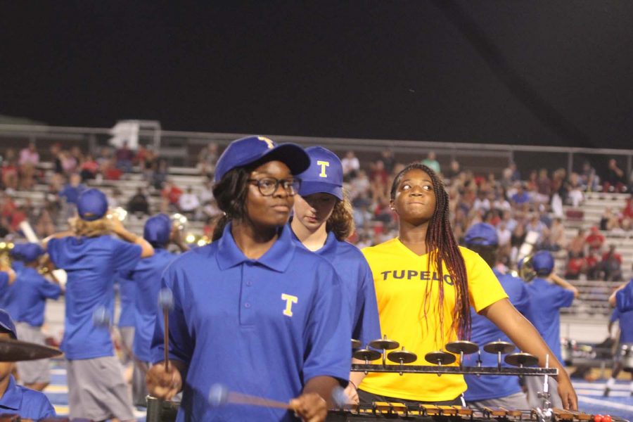 Shunte Smith, 11, watching the drum major for tempo during the THS marching bands halftime performance