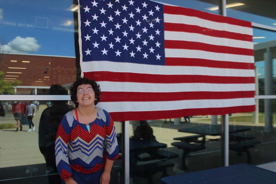 Autumn Woods posing in front of the American flag for America day