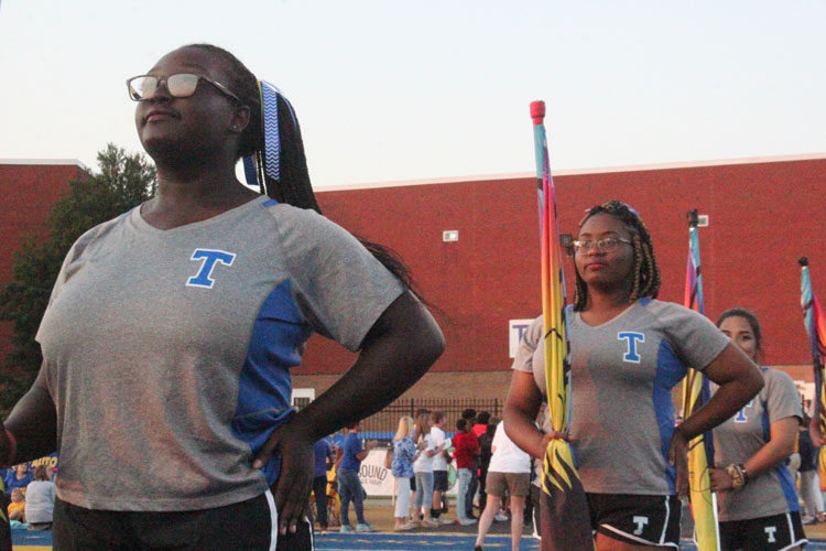 Kaitlyn Dixon (12) and Nikya Fields (12) stand in confidence as they march onto field