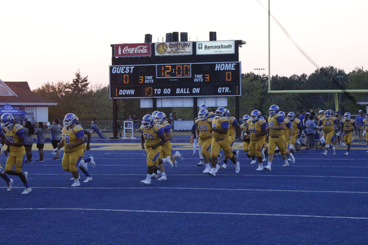 Tupelo football players run out 