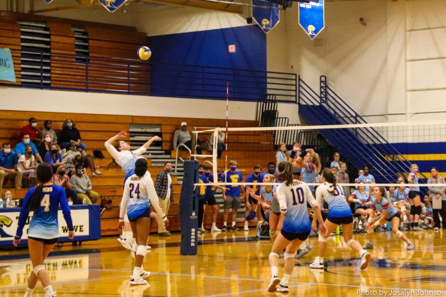 maggie griggs hits while mallory peters, autum peters, and allysa hawes gets ready to pass the block