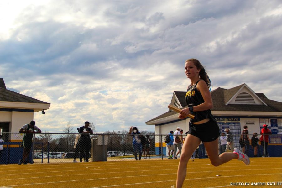 Emma Scruggs runs relay at the Tupelo invitational on March 11.
