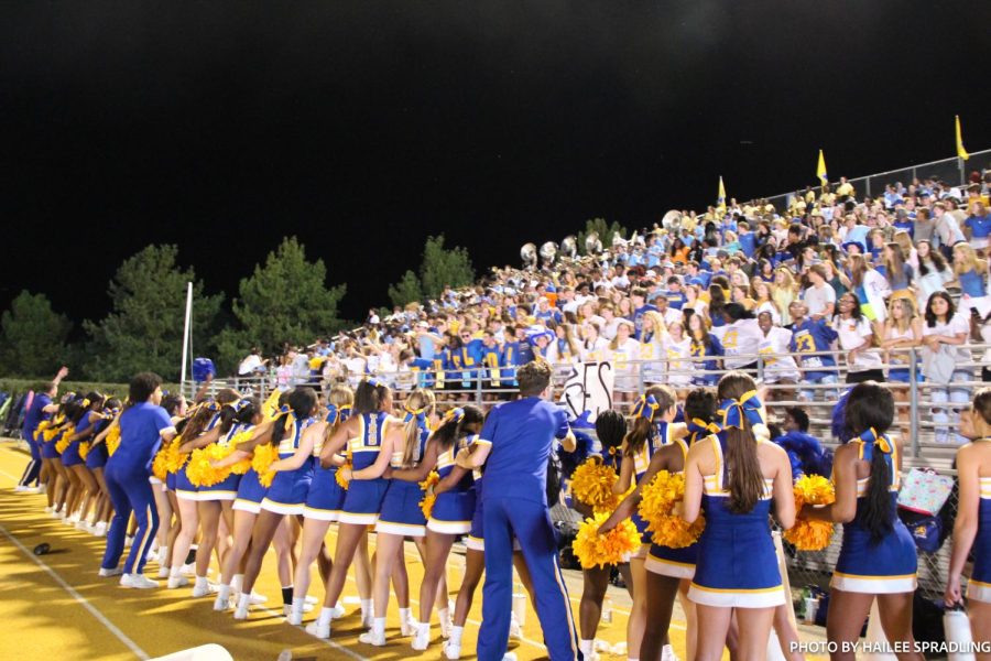 Cheer team and student section cheer for their winning team in the last quarter