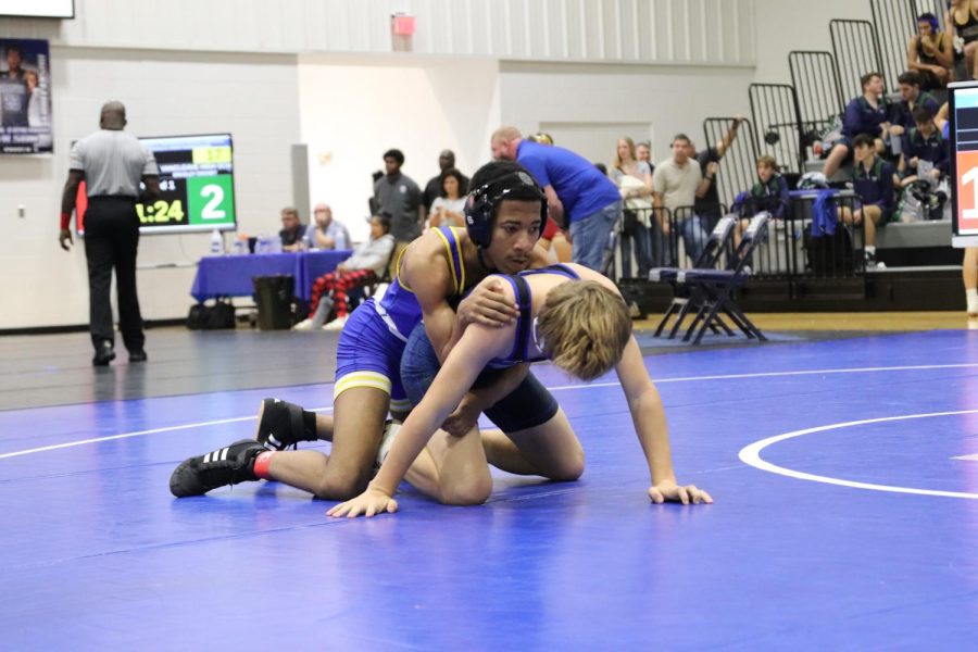 Camden Shaw (10) is on top of the opponent while he is in a referee position. 