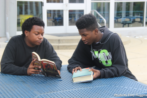 Jackson Hollbrook and Azjea Johnson discuss books during a club meeting