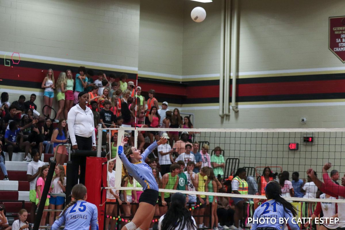 Sarah Foster Brown jumps up to hit the ball.