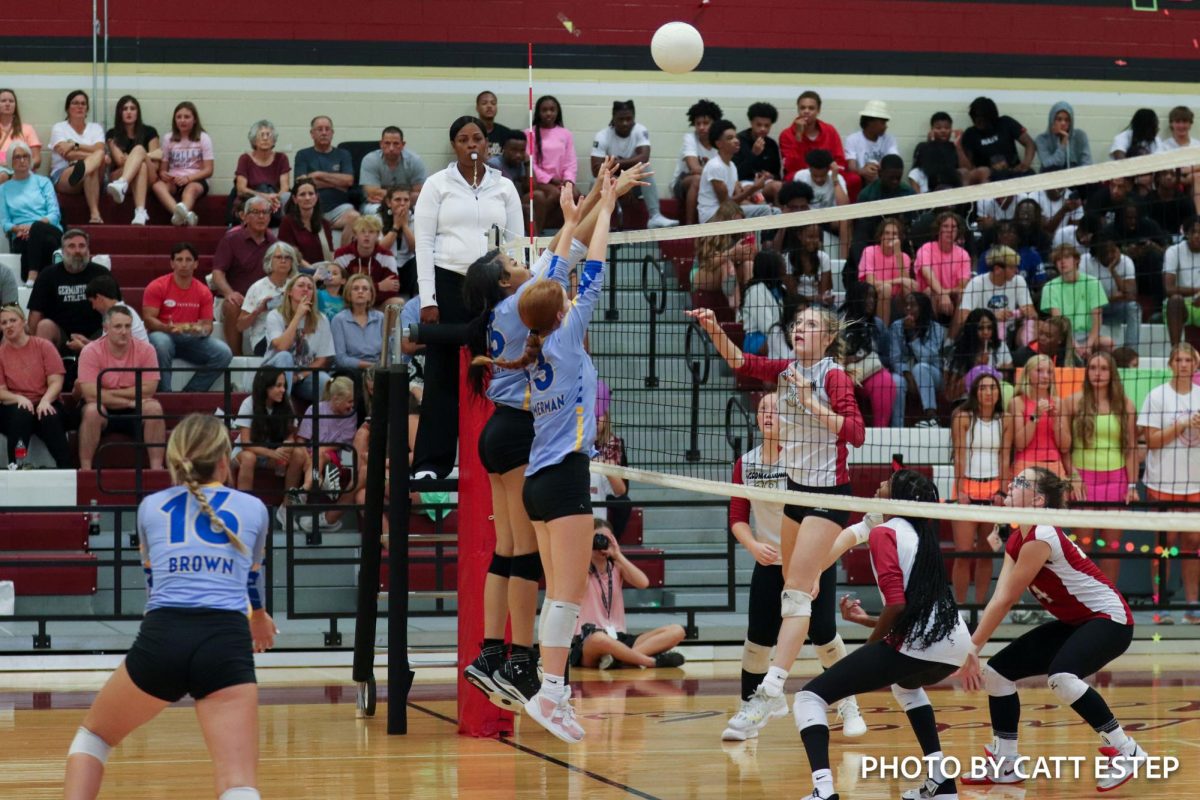 Kennedi Simmons and Loren Zimmerman jump up to block the ball from Germantown. 