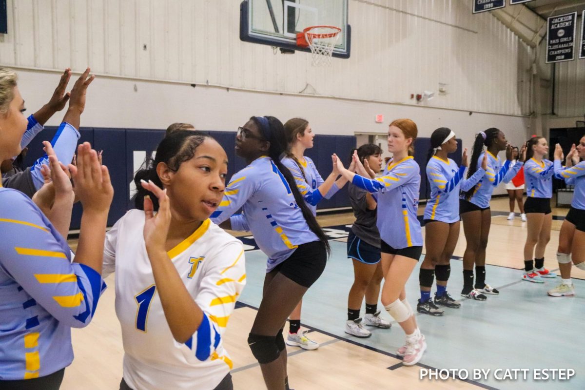 The team cheers on the varsity girls as they get ready to play Jackson Academy. 