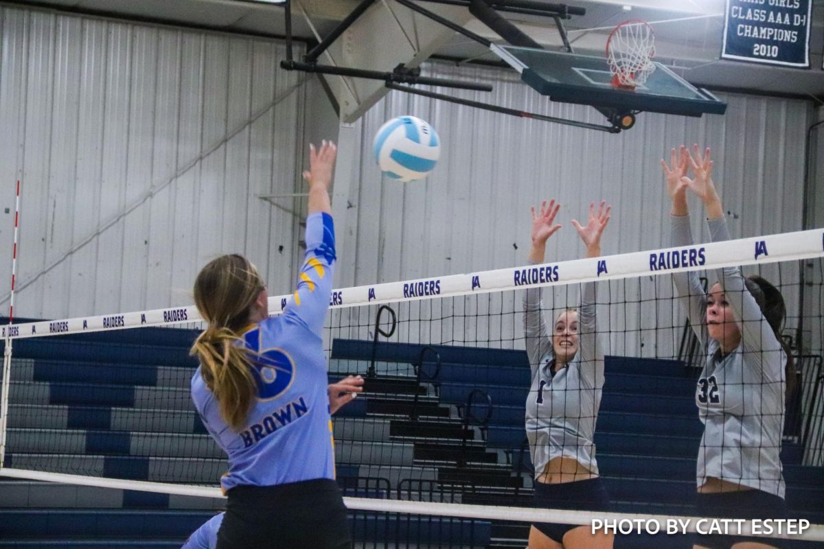 Sarah Foster Brown hits the ball over the net.