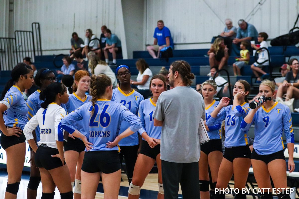 Coach Martin discuses with the varsity during a timeout on how to adjust their play. 