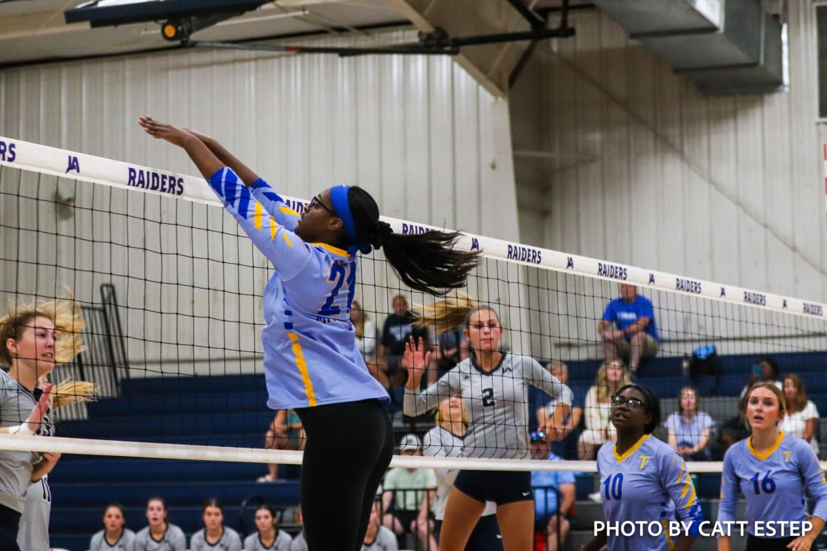 Arranda Mitchell blocks over the net. 