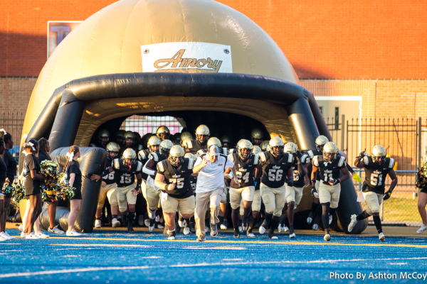 Amory Football team runs out the helmet before kickoff.