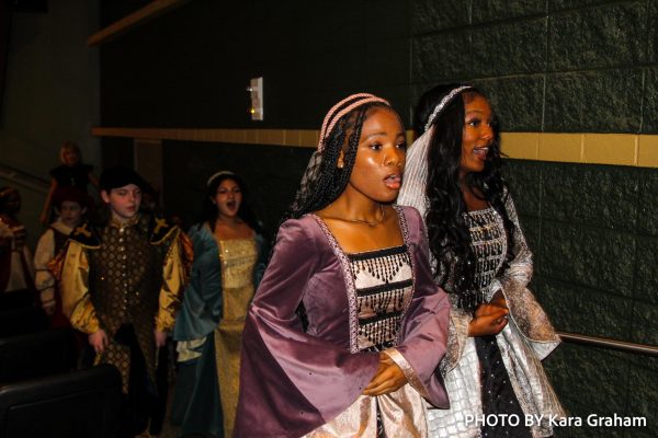 Chloe Shaw (11) and Hannah White exit the PAC through the aisles after their performance