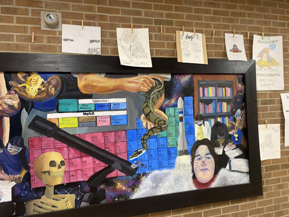 Mole Day posters and flyers hung around the Science mural.
