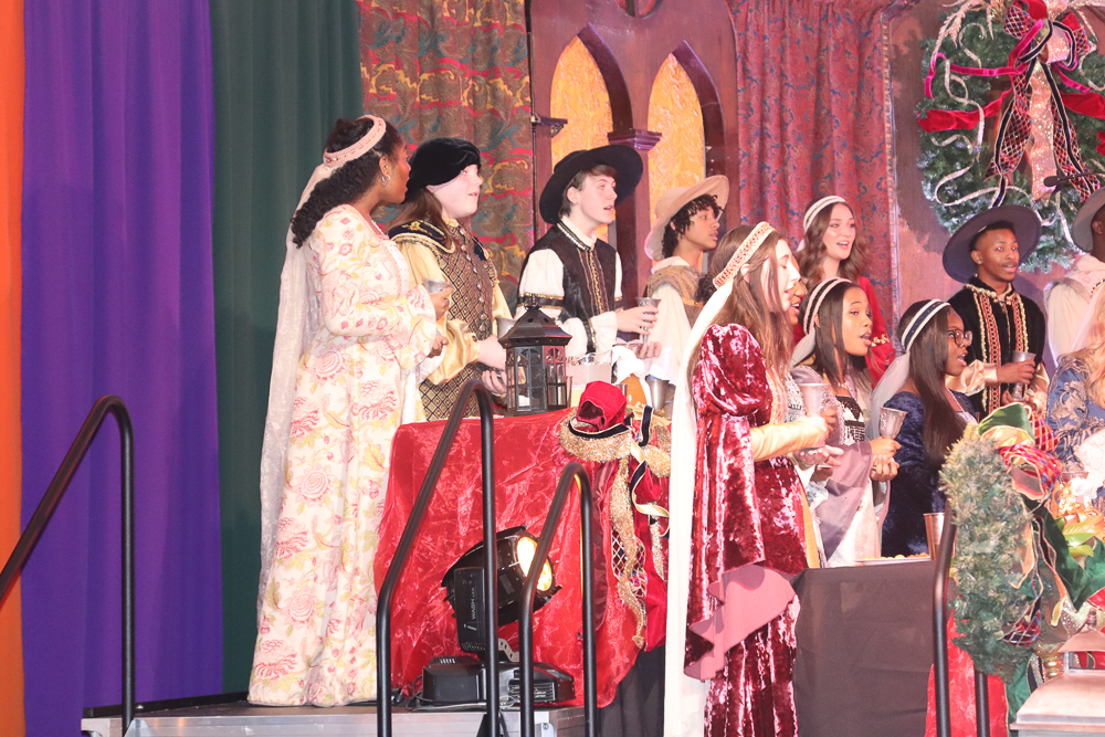 Madrigals prepares to sing about a Wassail. Wassail is a spiced cider used in Yuletide rituals.