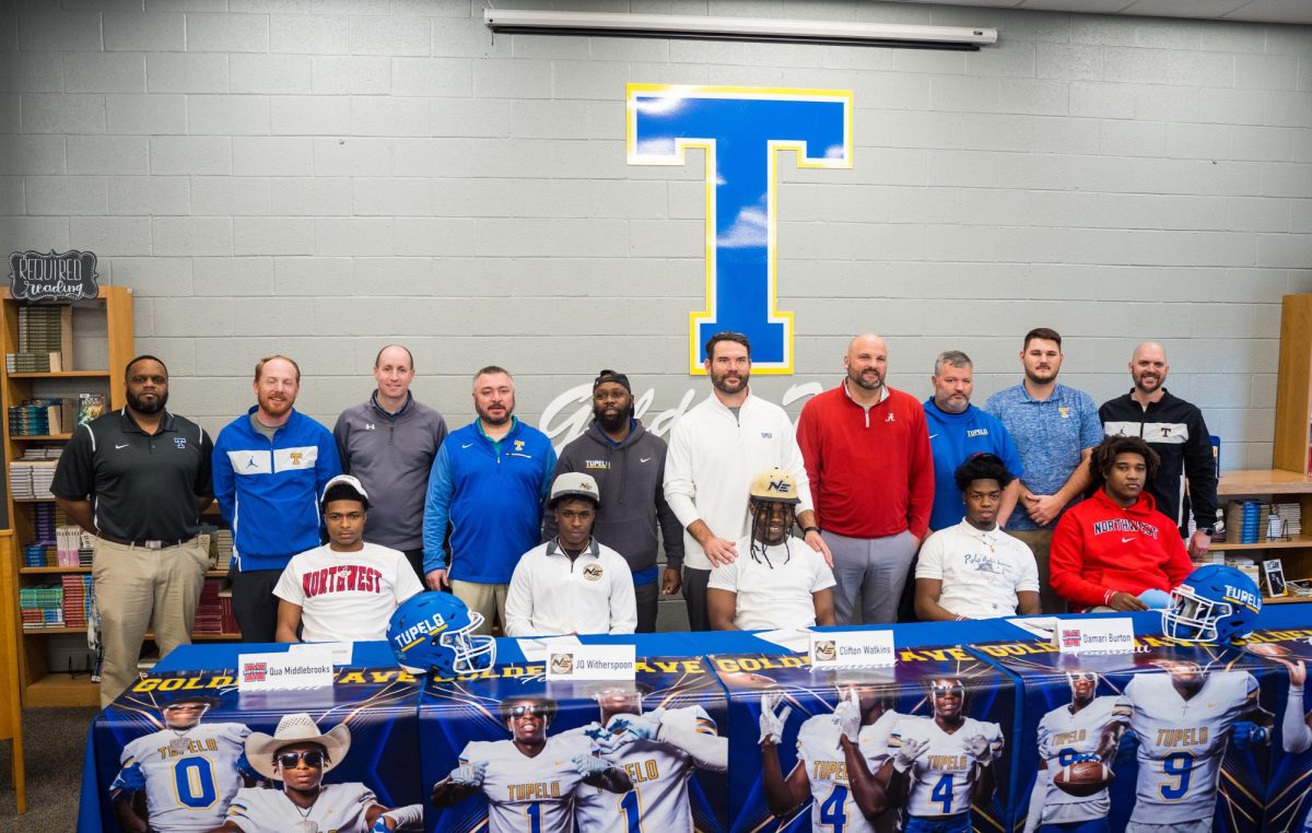 Football Players and Coaches Pose for a Picture