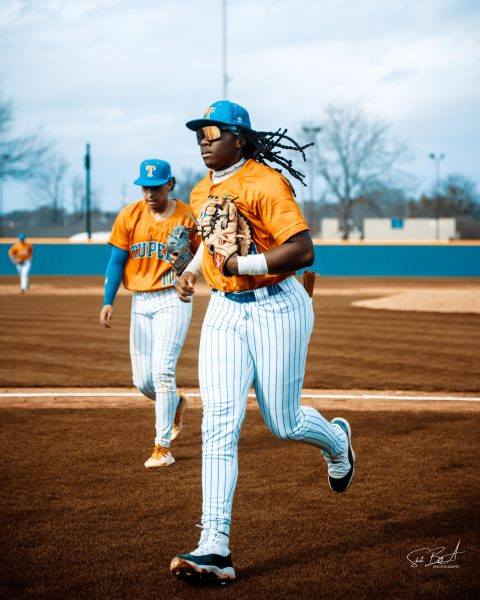 Tyler Johnson, senior, runs in after a successful inning.  
