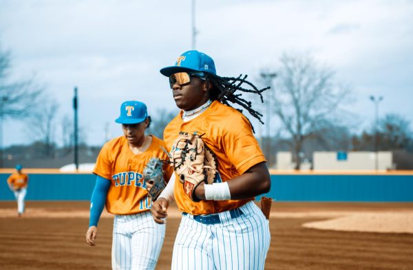 Tyler Johnson, senior, runs in after a successful inning.  