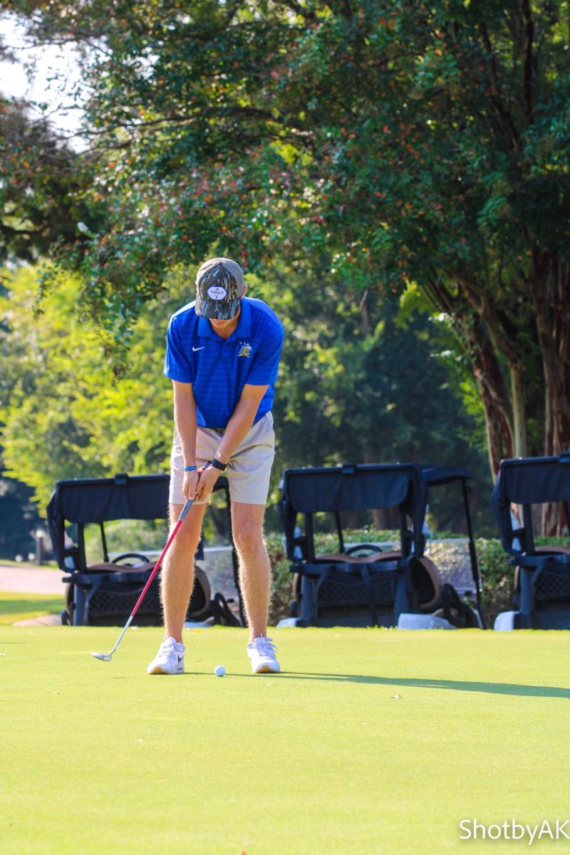 Sam practicing putting before the game takes off.
