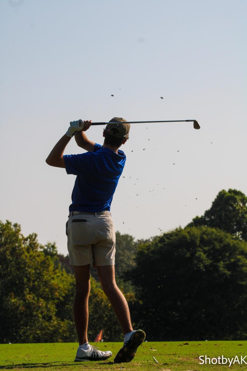 Brody WIlson swinging his club under the clear country club sky.