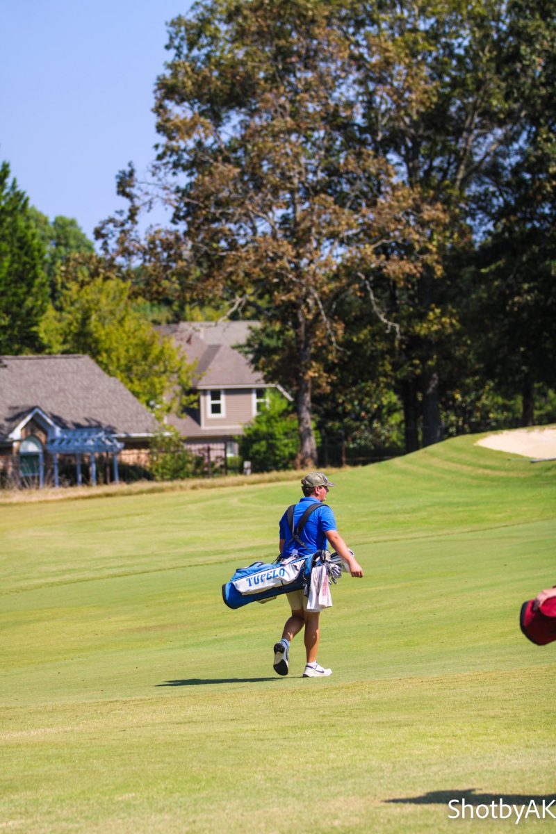 Miles enis walking through the fairway embracing the beauty of nature out on the golf course.