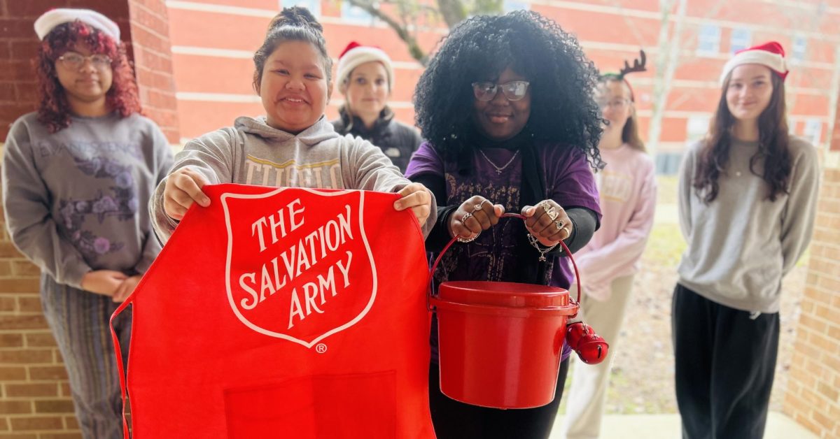 Students holding the salvation army bucket