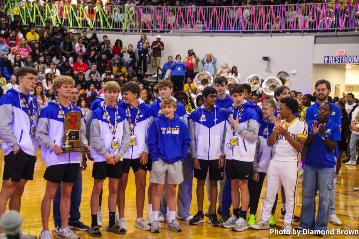 XC Boys holding trophy at pep rally
