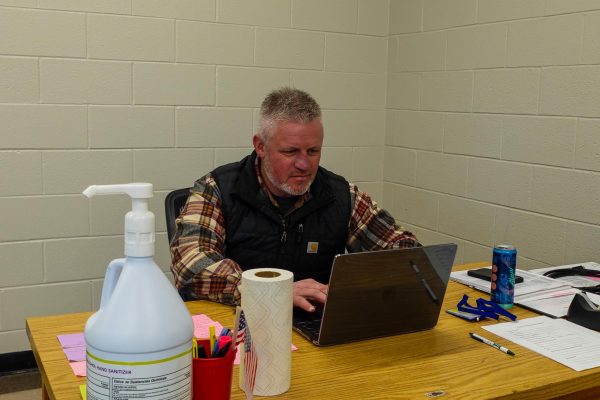 Career Coach, Bass sitting on his laptop
