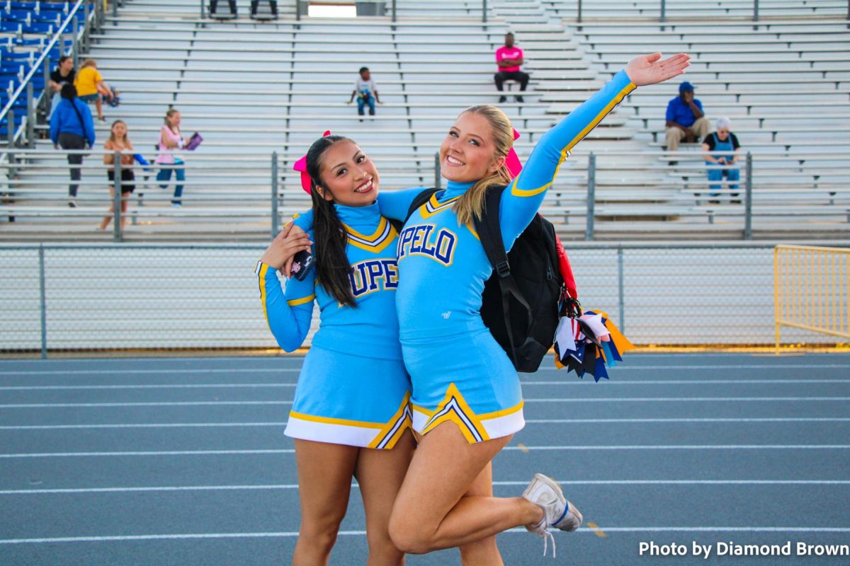 Vanessa Sanchez and Maggie Benjamin ready to cheer on the football team