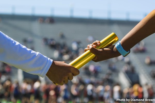Zaria Bell passing the baton to Serentee Jenkins