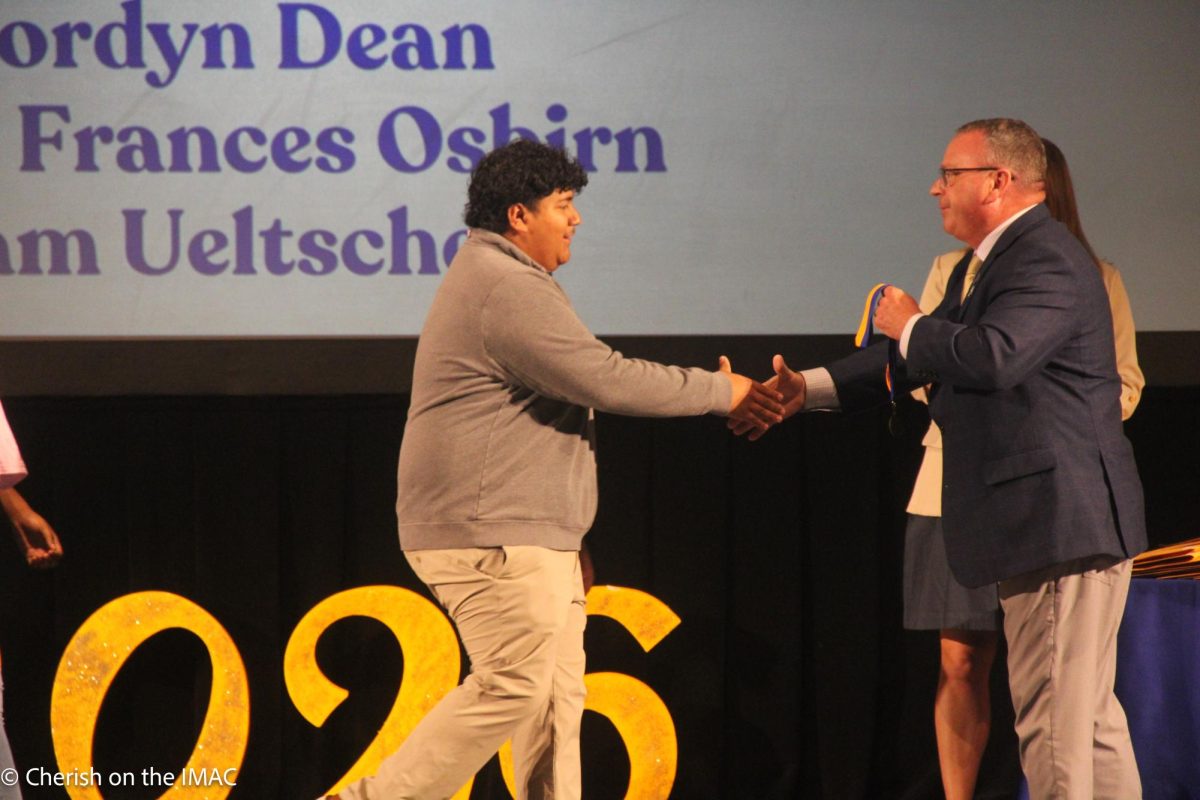 Edgar Cruz getting his award from Mr. Enis