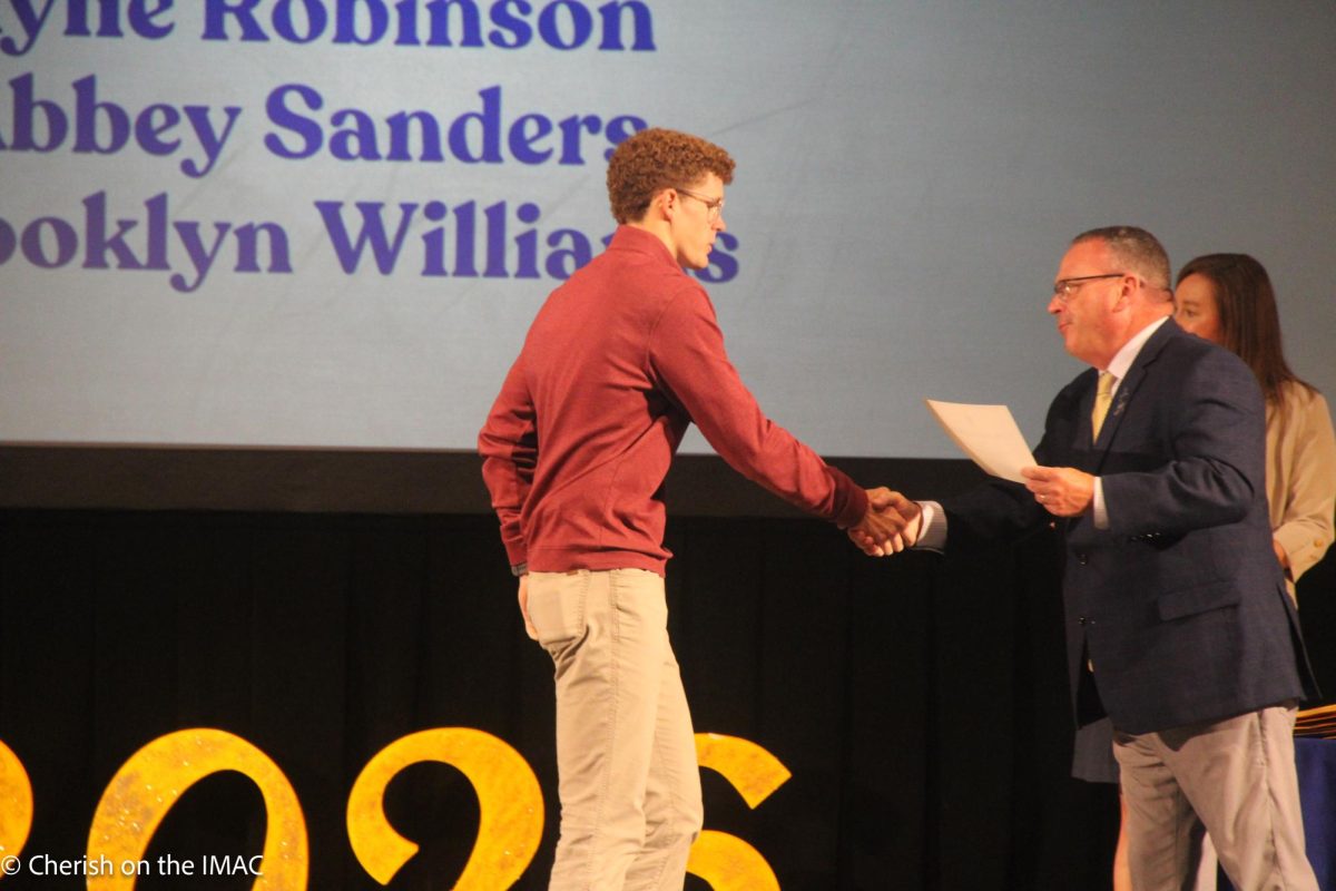 Mason Cordell getting his award from Mr. Enis