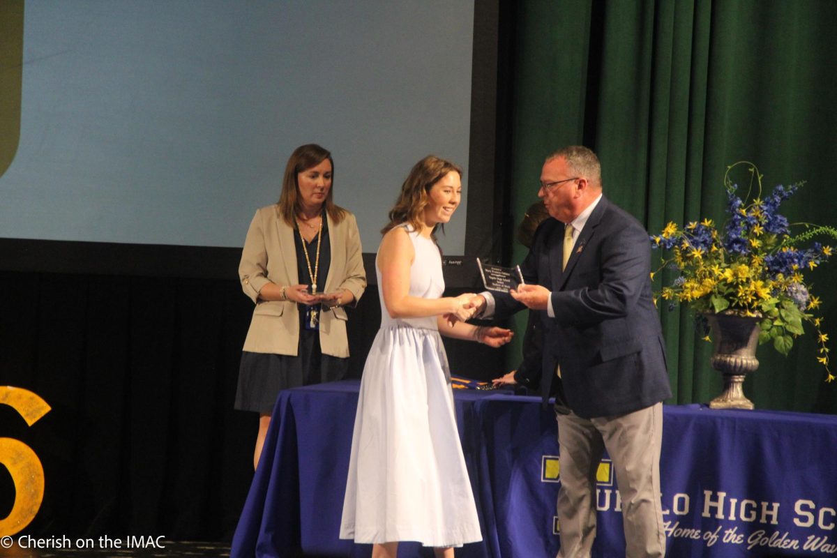 Mary Frances Osbirn getting her award from Mr. Enis