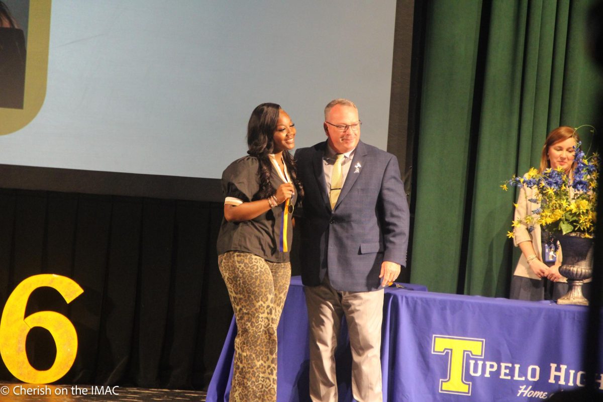 Amyah Dancer getting her award from Mr. Enis